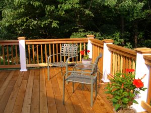 Deck & Fence Company Ladue MO Two chairs and flowerpots on gorgeous wood deck with rails