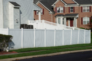 Deck and Fence Company Glendale MO white vinyl fence with brick home in background