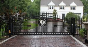 stylish gate crossing brick driveway