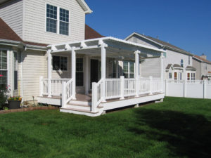white deck and pergola on back of home